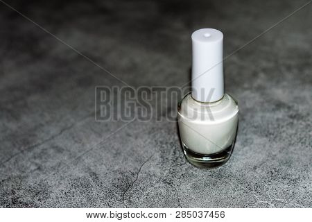 Bottle Of White Nail Polish On A Marble Slab
