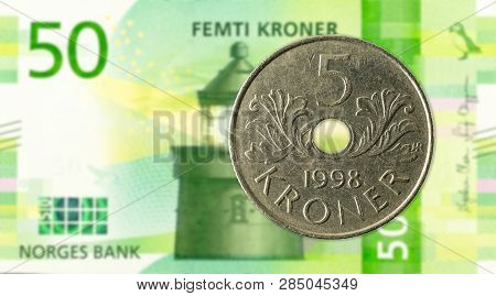 5 Norwegian Krone Coin Against 50 New Norwegian Krone Banknote