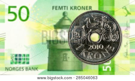 1 Norwegian Krone Coin Against 50 New Norwegian Krone Banknote