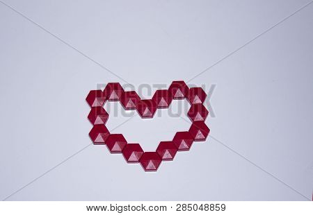 Red Heart Made Of Mosaic In The Center On A Blue Background