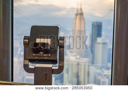 Binoculars On The Background Of Kuala Lumpur Cityscape. Panoramic View Of Kuala Lumpur City Skyline 