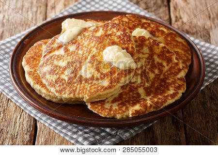 Freshly Made Sweet Griddle Cakes With Butter Close Up On A Plate. Horizontal