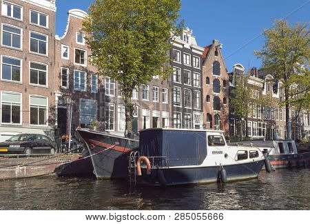 Moored Boats Onone Of The Canals Of Amsterdam On Sunny October Day