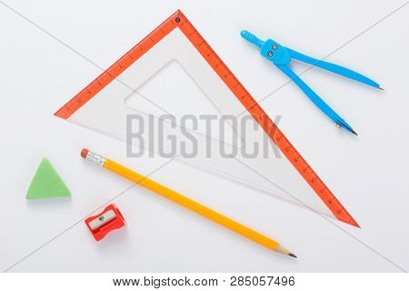 school set and ruler at white background, top view