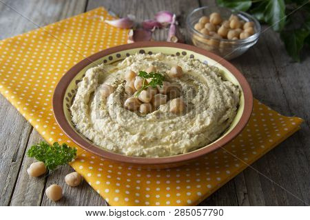 Delicious Homemade Hummus Pasta With Olive Oil And Cheakpeas. Wooden Table.