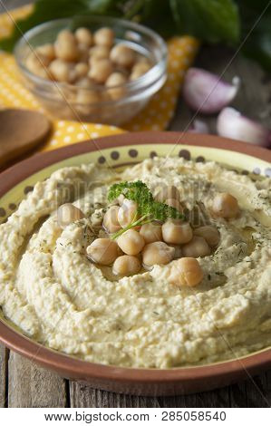 Delicious Homemade Hummus Pasta With Olive Oil And Cheakpeas. Wooden Table.