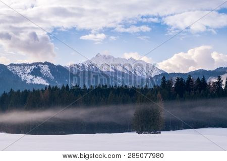 View From Bad Mitterndorf To Snow Covered Mountain Kammspitz On A Cloudy Day In Winter In Styria, Au