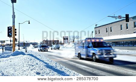 Bemidji, Mn - 8 Feb 2019: Two Ambulances With Sirens And Lights Flashing Rush To An Emergency On A S