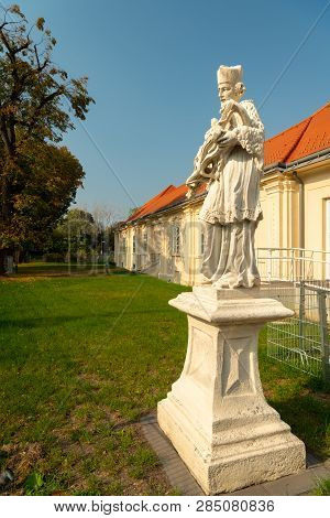 A Stone Sculpture Of Saint Johannes Nepomuk In Vienna, On A Sunny Day In Summer