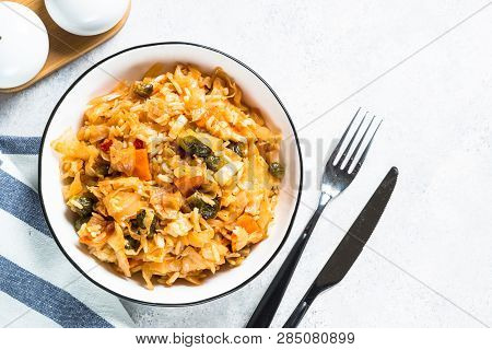 Cabbage Stew With Rice And Vegetables. Meatless Vegan Dish. Top View On Light Stone Table.