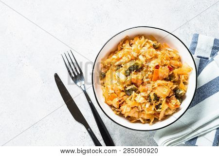 Cabbage Stew With Rice And Vegetables. Meatless Vegan Dish. Top View On Light Stone Table.