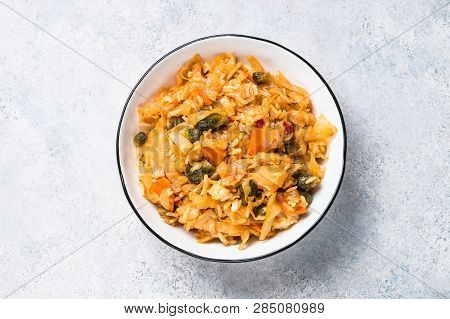 Cabbage Stew With Rice And Vegetables. Meatless Vegan Dish. Top View On Light Stone Table.