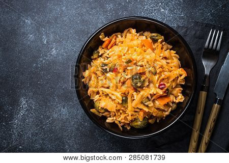 Cabbage Stew With Rice And Vegetables. Meatless Vegan Dish. Top View On Black Stone Table.