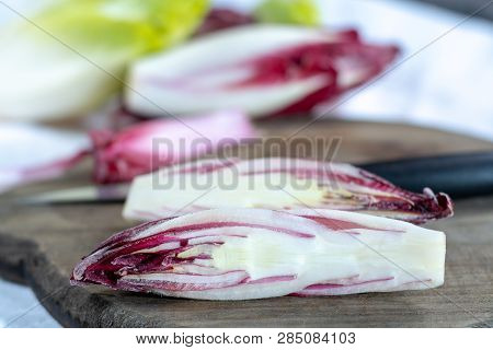 Group Of Fresh Green Belgian Endive Or Chicory And Red Radicchio Vegetables, Also Known As Witlof Sa