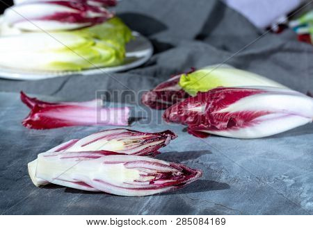 Group Of Fresh Green Belgian Endive Or Chicory And Red Radicchio Vegetables, Also Known As Witlof Sa