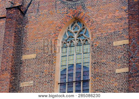 Old Decorated Cathedral Stained Glass Window And Brick Wall, Outdoor View
