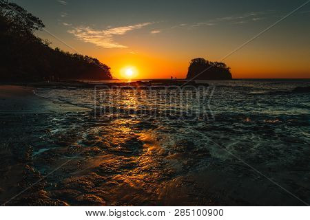Orange Teal Sunset On A Beautiful Beach. Beautiful Vivid Sunset Over Beach With The Water Vivid. A B
