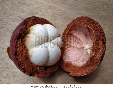 Mangosteen Fruit Cut Into Half Showing Its White Seeds.