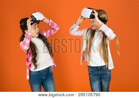Discover Virtual Reality. Kids Girls Play Virtual Reality Game. Friends Interact In Vr. Explore Alte