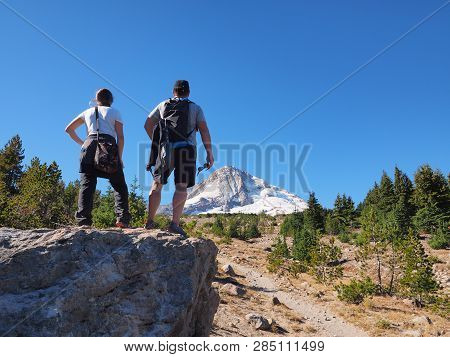 Hiking Couple On The Tilly Jane Trail On Mount Hood, Oregon, With The Volcanos North Face And Eliot 