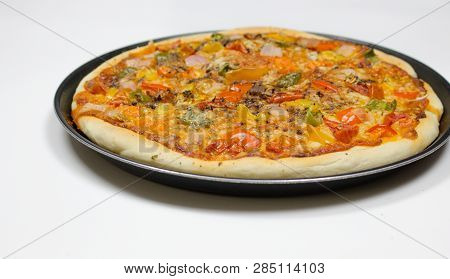 Pizza with sauce, bellpepper, seasoning, tomato in white background