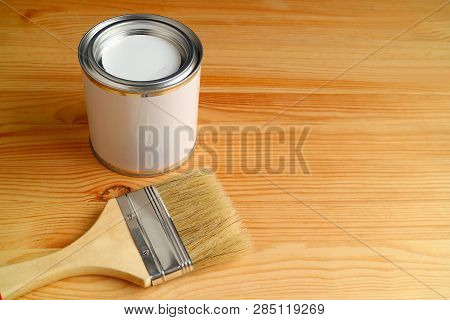 Paintbrush And Paint Can Isolated On Wooden Background With Free Space For Design Or Text