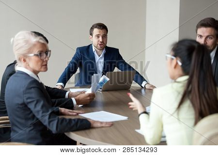Angry Executive Shouting Having Disagreement With Employee At Group Meeting