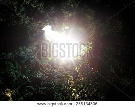 Sun Brust Or Sun Flare Coming From Top Of Underground Cave Opening. Concept Of Success, Hope In The 