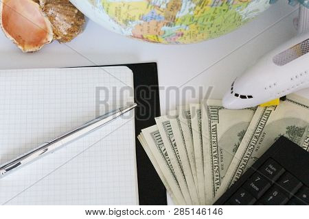 Planning A Trip Around The World. On Holiday With The Whole Family. In The Photo: Plane, Money, Shel