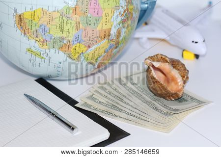 Planning A Trip Around The World. On Holiday With The Whole Family. In The Photo: Plane, Money, Shel