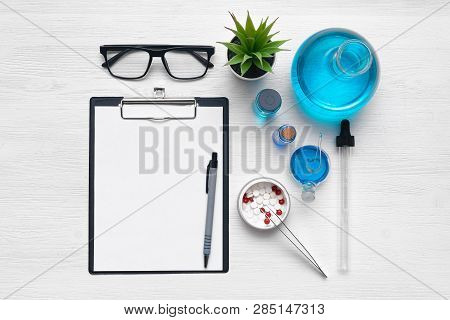 Medical Examination Mockup. Researching Results Blank Sheet, Tablets In A Jar And A Chemical Reagent