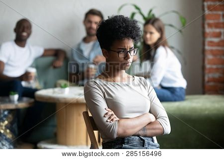 Black Girl Outcast Sitting Apart From Peers In Cafeteria