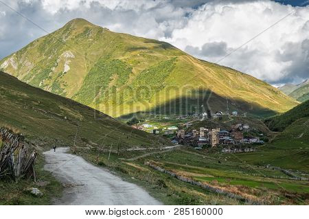Old Authentic Ushguli Village With Famous Svan Towers Far In The Distance In Georgian Mountains