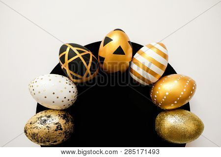 Stylish Easter Golden Decorated Eggs On Black Plate Isolated On White Background. Trendy Flat Lay Ea