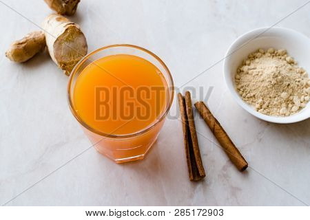 Jamu Healthy Asian Drink With Turmeric And Cinnamon Stick, Orange Juice