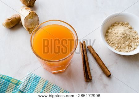 Jamu Healthy Asian Drink With Turmeric And Cinnamon Stick, Orange Juice