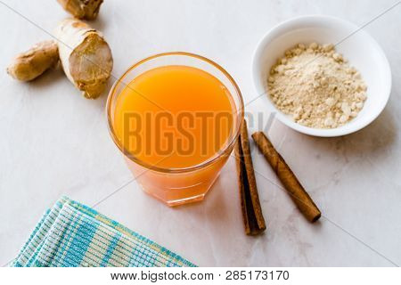 Jamu Healthy Asian Drink With Turmeric And Cinnamon Stick, Orange Juice