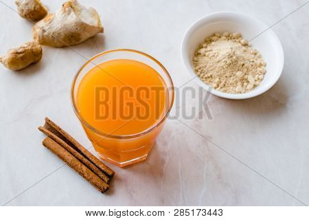 Jamu Healthy Asian Drink With Turmeric And Cinnamon Stick, Orange Juice