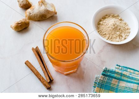 Jamu Healthy Asian Drink With Turmeric And Cinnamon Stick, Orange Juice