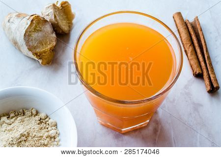 Jamu Healthy Asian Drink With Turmeric And Cinnamon Stick, Orange Juice
