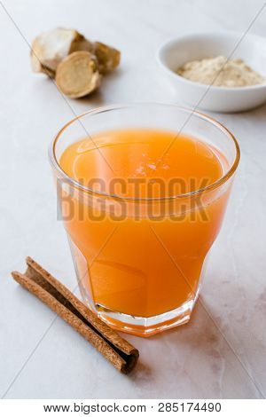 Jamu Healthy Asian Drink With Turmeric And Cinnamon Stick, Orange Juice