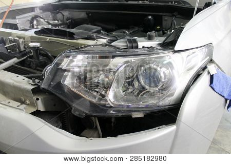 Macro View Of Modern Automobile In Autoservice With Auto Projector Lens. Mechanic Car Repair Service