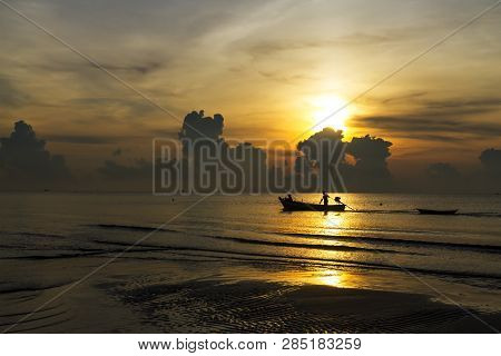 Sunrise In The Morning And Fisherman On Beach At Thung Wua Lan Beach, Chumphon Province Thailand