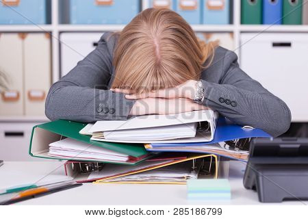 Stressed Woman At The Office. Concept For Burnout And Overwork In Business Situations.