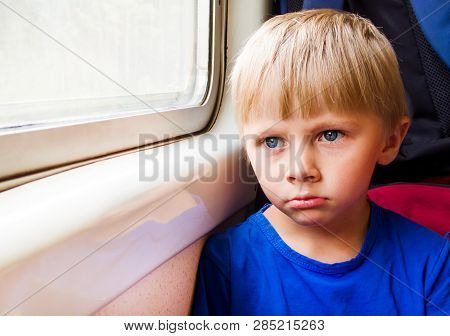 Sad Child Boy Sit In The Train By The Window