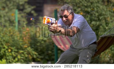 Senior Man With Toy Gun Fight On Nature