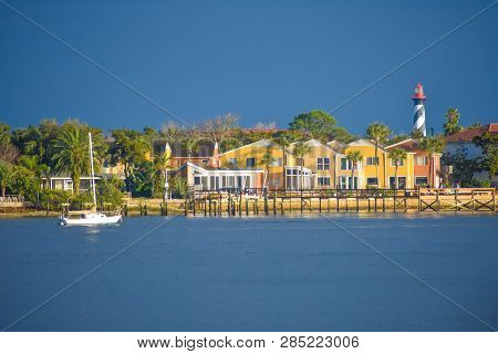 St. Augustine, Florida. January 26 , 2019. Colorful Dockside And Old Lighthouse On Blue Sky Backgrou