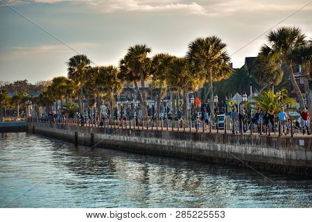 St. Augustine, Florida. January 26, 2019. People Walking In Boardwalk On Sunset Background.