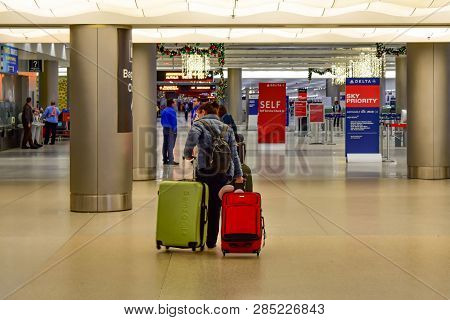 Miami, Florida. January 05, 2019. Woman Walking With Colorful Suitcases At Miami International Airpo