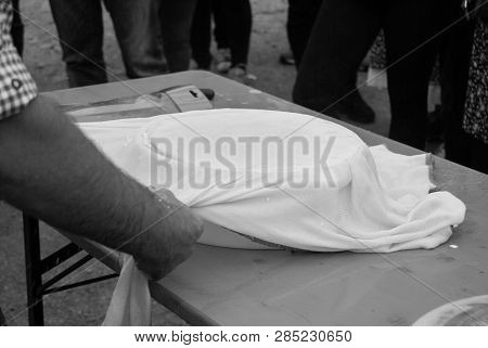 Man Using A Circular Mold To Shape The Cheese